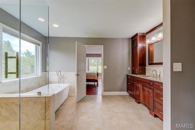 322 Gerard Ln, Moscow Mills, MO 63362 - ensuite bathroom with a freestanding tub, vanity, recessed lighting, and baseboards