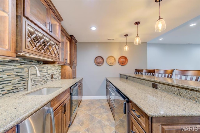 322 Gerard Ln, Moscow Mills, MO 63362 - kitchen featuring baseboards, a sink, decorative backsplash, brown cabinets, and recessed lighting
