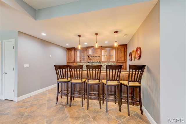 322 Gerard Ln, Moscow Mills, MO 63362 - indoor bar with decorative backsplash, baseboards, decorative light fixtures, recessed lighting, and light stone finish floors