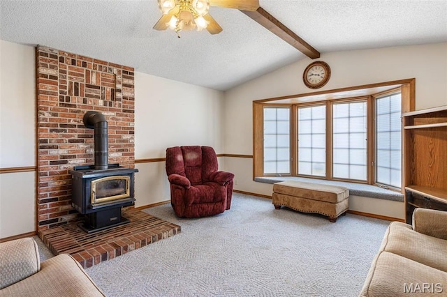423 Rice Rd, Bonne Terre, MO 63628 - living room with a textured ceiling, ceiling fan, carpet floors, a wood stove, and baseboards