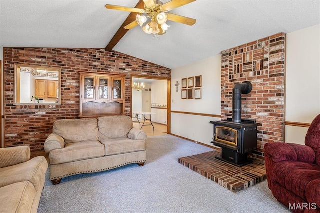 423 Rice Rd, Bonne Terre, MO 63628 - carpeted living room featuring a ceiling fan, a wood stove, brick wall, baseboards, and a textured ceiling