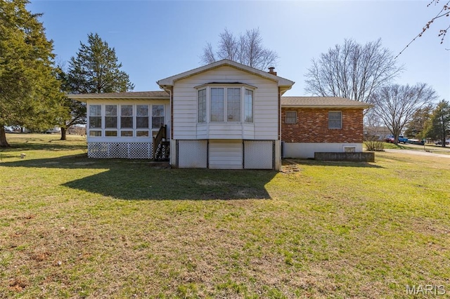 423 Rice Rd, Bonne Terre, MO 63628 - rear view of property featuring a lawn and a sunroom