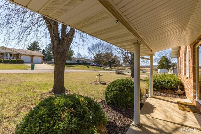 423 Rice Rd, Bonne Terre, MO 63628 - view of green lawn with a garage and concrete driveway