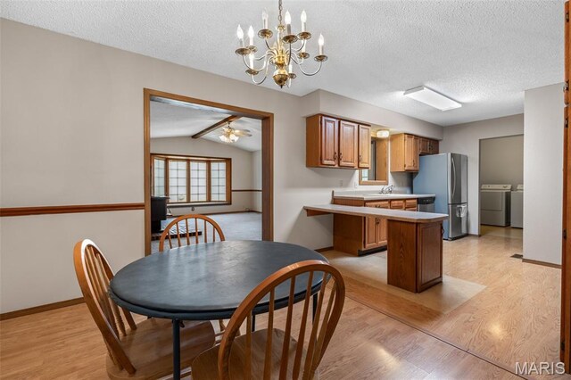 423 Rice Rd, Bonne Terre, MO 63628 - kitchen with freestanding refrigerator, washer and clothes dryer, light wood-type flooring, a textured ceiling, and light countertops