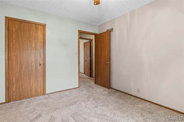 423 Rice Rd, Bonne Terre, MO 63628 - unfurnished bedroom featuring carpet, a textured ceiling, and baseboards