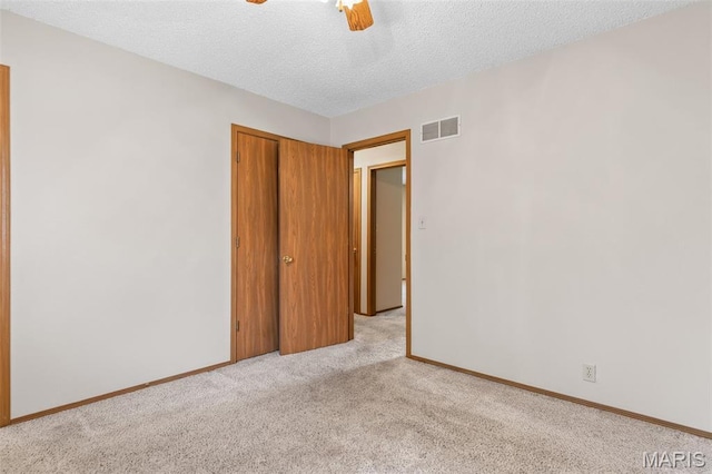 423 Rice Rd, Bonne Terre, MO 63628 - unfurnished bedroom with light colored carpet, a textured ceiling, baseboards, ceiling fan, and a closet