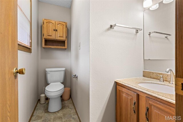 423 Rice Rd, Bonne Terre, MO 63628 - bathroom with toilet, vanity, and baseboards