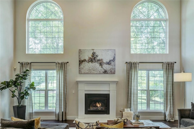 1155 Whitmoor Dr, Weldon Spring, MO 63304 - living room featuring a towering ceiling and a warm lit fireplace