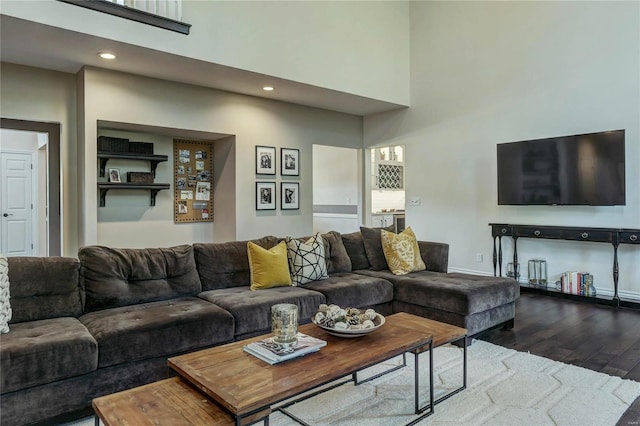 1155 Whitmoor Dr, Weldon Spring, MO 63304 - living area featuring dark wood-type flooring, a high ceiling, and recessed lighting