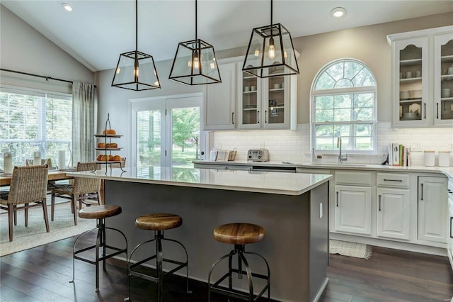 1155 Whitmoor Dr, Weldon Spring, MO 63304 - kitchen with a sink, a kitchen island, plenty of natural light, vaulted ceiling, and recessed lighting
