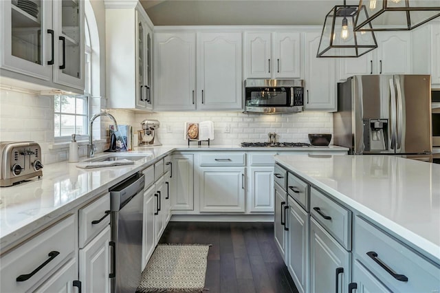 1155 Whitmoor Dr, Weldon Spring, MO 63304 - kitchen featuring appliances with stainless steel finishes, dark wood finished floors, white cabinetry, glass insert cabinets, and a sink