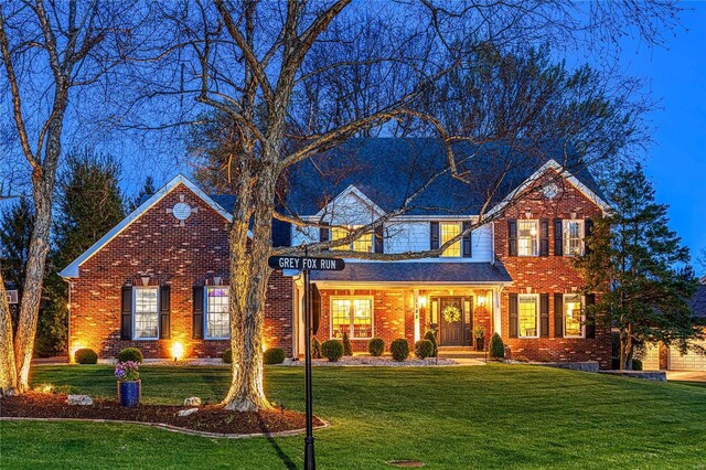 1155 Whitmoor Dr, Weldon Spring, MO 63304 - traditional-style home with a front lawn and brick siding