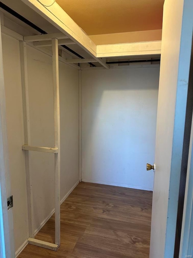 5220 Delcastle Dr, Florissant, MO 63034 - walk in closet with wood finished floors