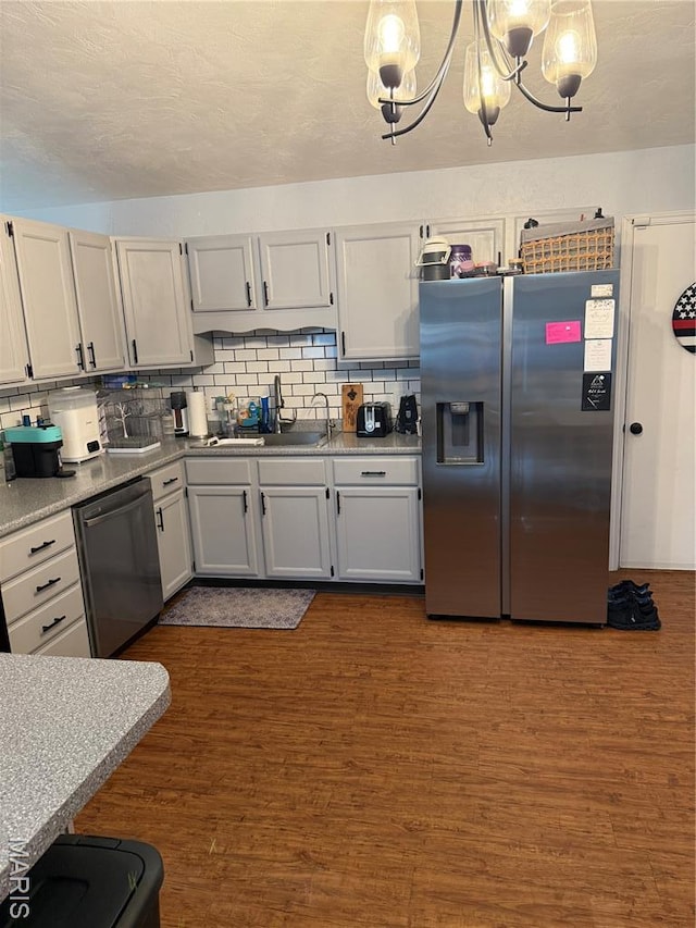 70 Innsbruck Ln, Shiloh, IL 62221 - kitchen featuring stainless steel appliances, a sink, tasteful backsplash, dark wood finished floors, and a chandelier