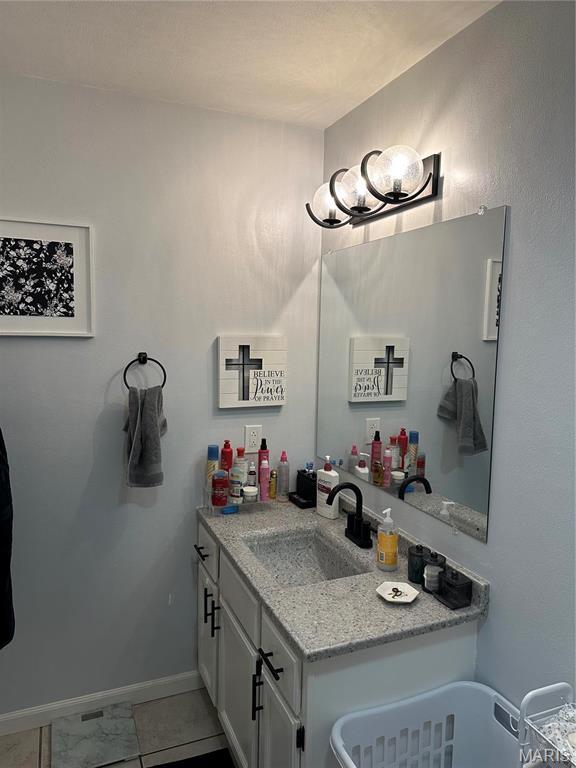 70 Innsbruck Ln, Shiloh, IL 62221 - bathroom with vanity, baseboards, and marble look tile flooring