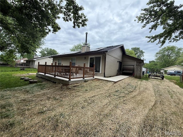 70 Innsbruck Ln, Shiloh, IL 62221 - rear view of property featuring a wooden deck, dirt driveway, an attached garage, and a chimney