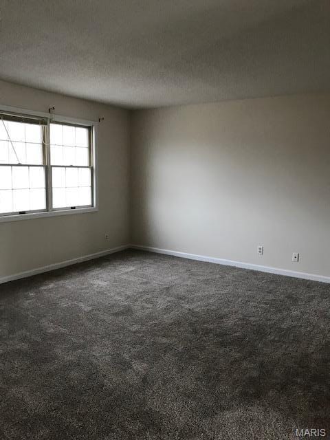 1723 Canary Cv, Brentwood, MO 63144 - empty room featuring dark carpet, baseboards, and a textured ceiling