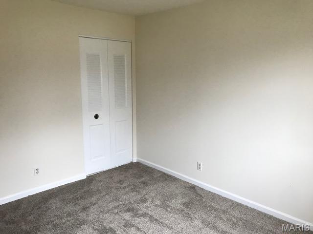 1723 Canary Cv, Brentwood, MO 63144 - unfurnished room with dark carpet and baseboards