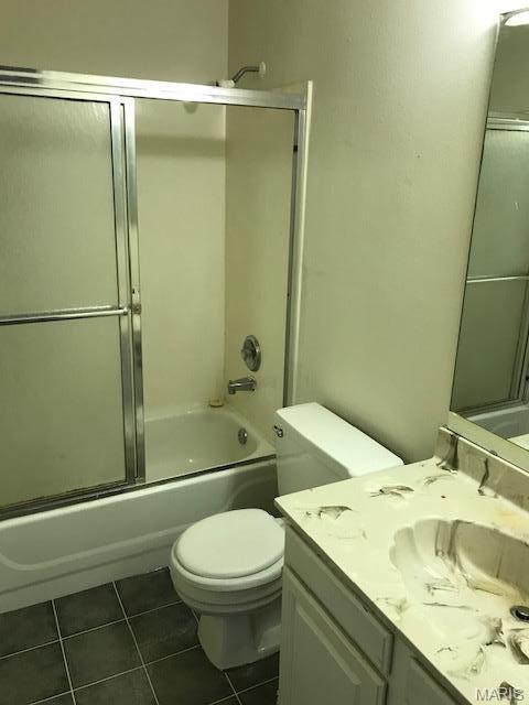 1723 Canary Cv, Brentwood, MO 63144 - bathroom featuring tile patterned flooring, toilet, vanity, and shower / bath combination with glass door