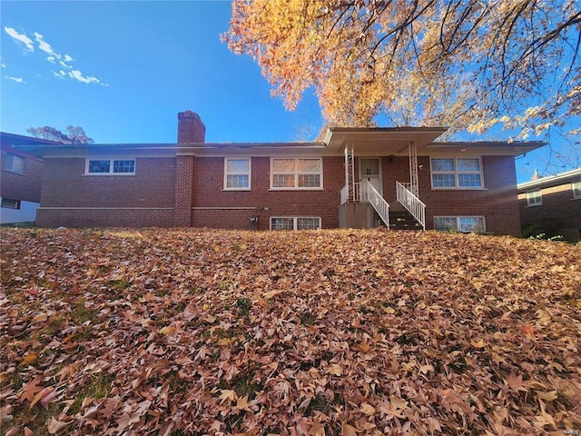 7712 Nacomis Dr, Saint Louis, MO 63121 - view of front of home with brick siding and a chimney