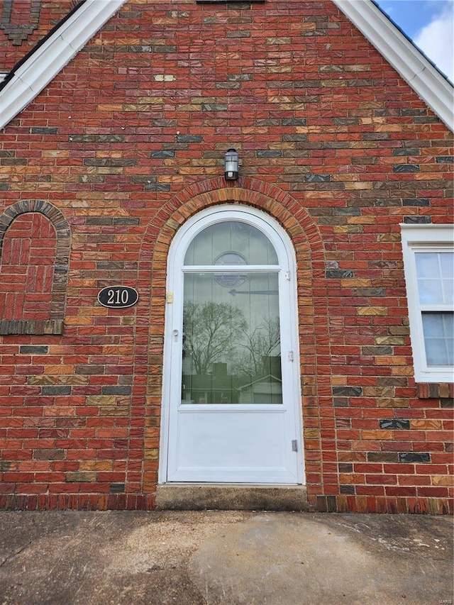 property entrance with brick siding