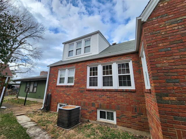 view of property exterior with brick siding