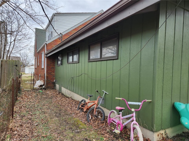view of side of property featuring fence