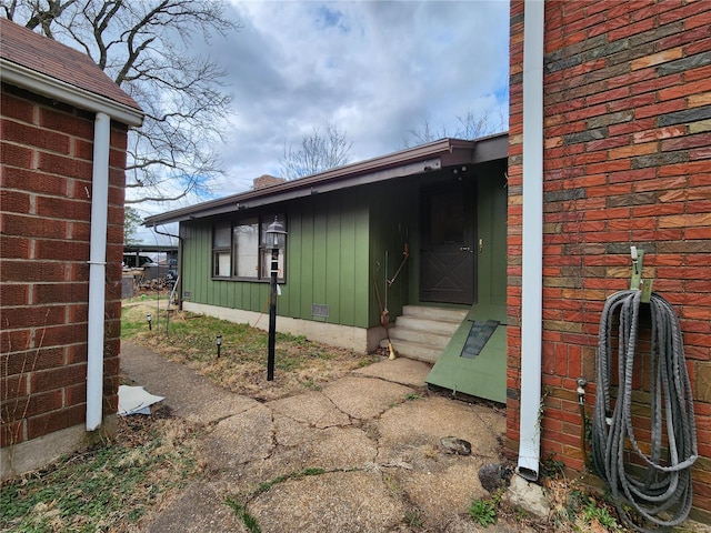doorway to property featuring board and batten siding