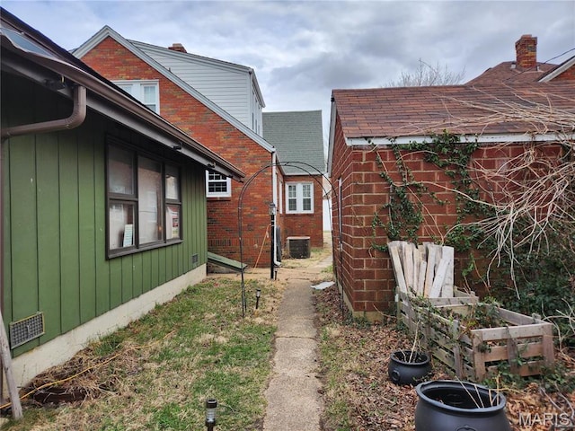 210 Linn St, Belle, MO 65013 - view of property exterior with a central AC unit and brick siding