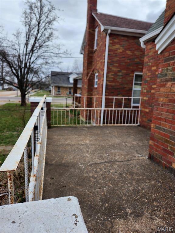 210 Linn St, Belle, MO 65013 - view of home's exterior featuring a chimney and brick siding