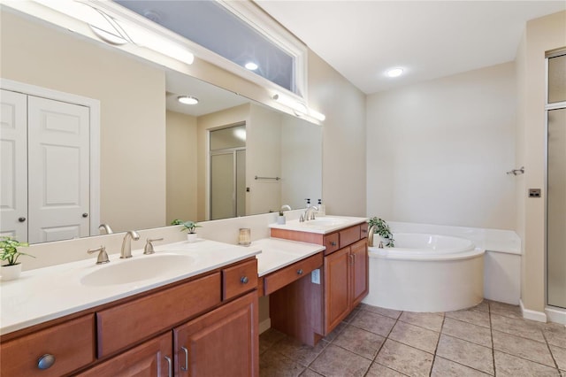 bathroom with a shower stall, a bath, tile patterned floors, and vanity