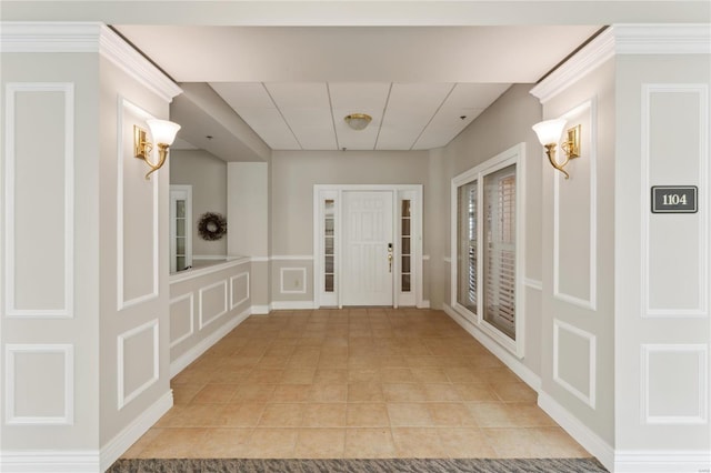 foyer featuring a paneled ceiling and light tile patterned flooring