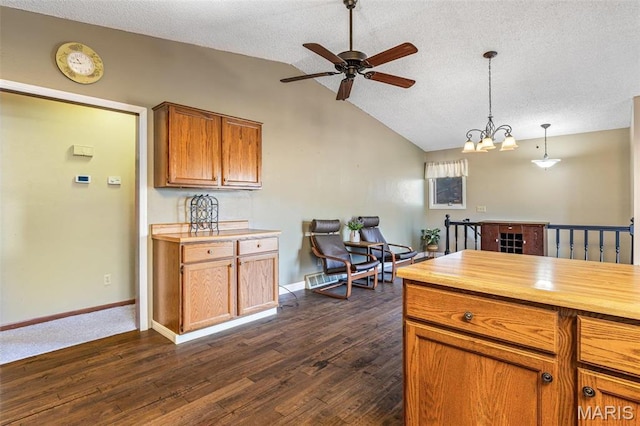 207 Normandie Dr, Bonne Terre, MO 63628 - kitchen featuring ceiling fan, dark wood finished floors, vaulted ceiling, a textured ceiling, and hanging light fixtures