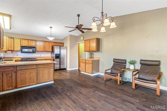 207 Normandie Dr, Bonne Terre, MO 63628 - kitchen featuring stainless steel appliances, light countertops, dark wood-style floors, lofted ceiling, and a textured ceiling