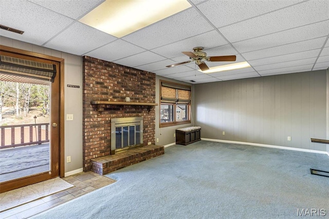 207 Normandie Dr, Bonne Terre, MO 63628 - unfurnished living room with healthy amount of natural light, a drop ceiling, a ceiling fan, carpet flooring, and a fireplace