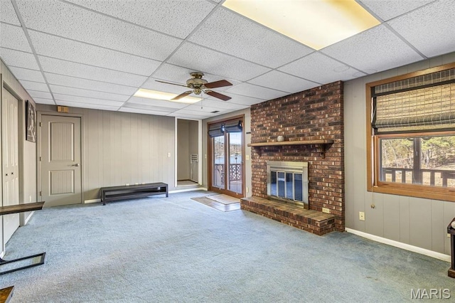 207 Normandie Dr, Bonne Terre, MO 63628 - unfurnished living room featuring a drop ceiling, carpet flooring, ceiling fan, and a brick fireplace