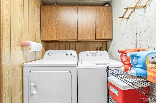 207 Normandie Dr, Bonne Terre, MO 63628 - laundry area with cabinet space, washing machine and dryer, and wood walls