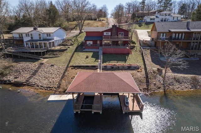 207 Normandie Dr, Bonne Terre, MO 63628 - dock area featuring a water view, a residential view, boat lift, and a lawn