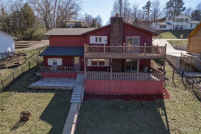 207 Normandie Dr, Bonne Terre, MO 63628 - back of property with stairway, a chimney, a deck, and a fenced backyard