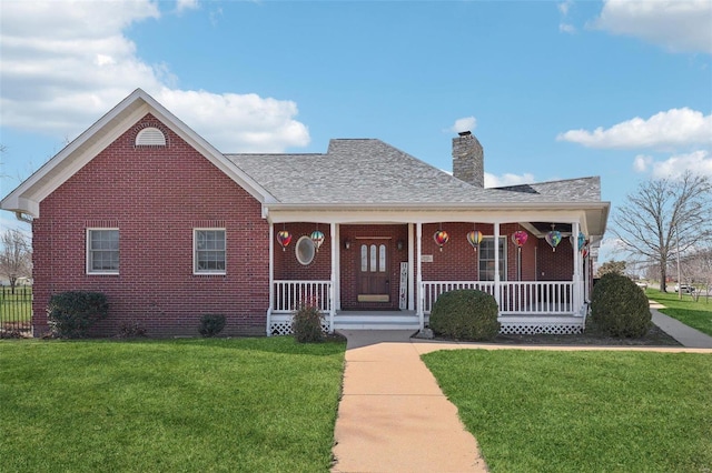 900 Deer Circle Dr, Carlyle, IL 62231 - view of front of house with brick siding, a front lawn, a chimney, a porch, and a shingled roof
