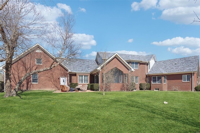 900 Deer Circle Dr, Carlyle, IL 62231 - view of front of house featuring brick siding, a front lawn, and a patio
