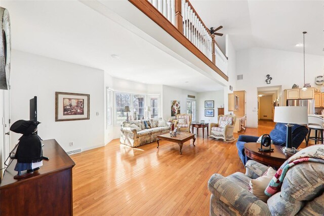 900 Deer Circle Dr, Carlyle, IL 62231 - living room featuring light wood-style flooring, a high ceiling, and baseboards