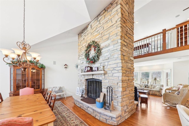 900 Deer Circle Dr, Carlyle, IL 62231 - living room featuring high vaulted ceiling, wood finished floors, a fireplace, and a chandelier
