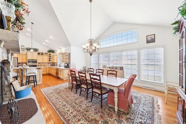 900 Deer Circle Dr, Carlyle, IL 62231 - dining area with a chandelier, light wood-style floors, and high vaulted ceiling