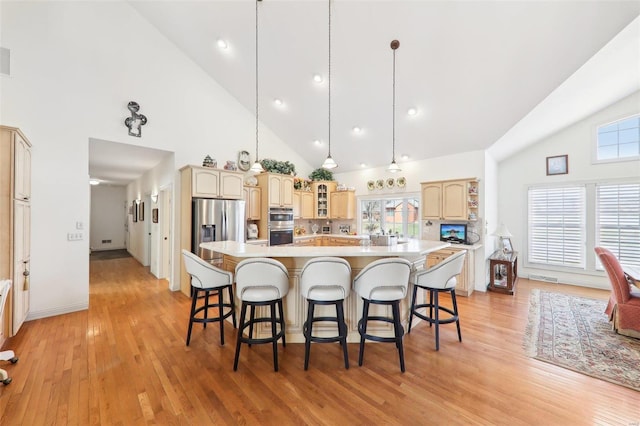 900 Deer Circle Dr, Carlyle, IL 62231 - kitchen featuring high vaulted ceiling, stainless steel appliances, light countertops, a kitchen bar, and a large island