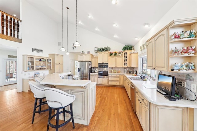 900 Deer Circle Dr, Carlyle, IL 62231 - kitchen with appliances with stainless steel finishes, light wood-type flooring, glass insert cabinets, light countertops, and a kitchen breakfast bar
