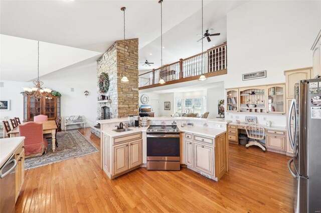 900 Deer Circle Dr, Carlyle, IL 62231 - kitchen featuring appliances with stainless steel finishes, open floor plan, ceiling fan, a sink, and high vaulted ceiling