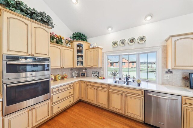 900 Deer Circle Dr, Carlyle, IL 62231 - kitchen featuring appliances with stainless steel finishes, a sink, lofted ceiling, light brown cabinets, and backsplash