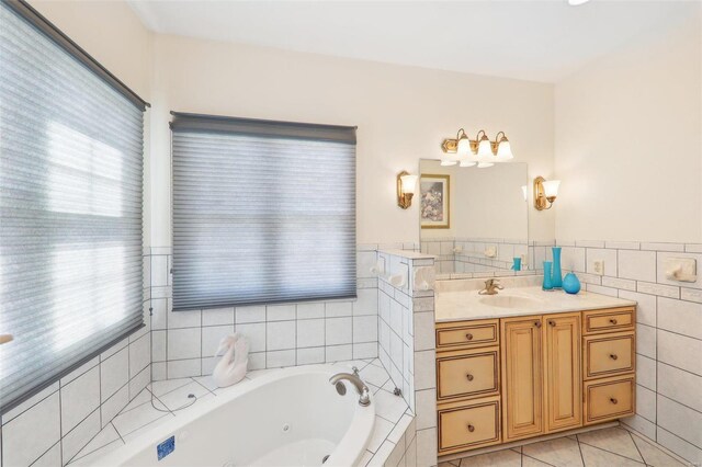 900 Deer Circle Dr, Carlyle, IL 62231 - full bath featuring tile walls, a jetted tub, vanity, tile patterned floors, and a wainscoted wall