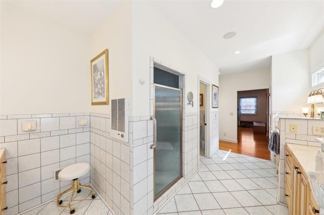 900 Deer Circle Dr, Carlyle, IL 62231 - full bath featuring tile patterned floors, a stall shower, vanity, tile walls, and recessed lighting